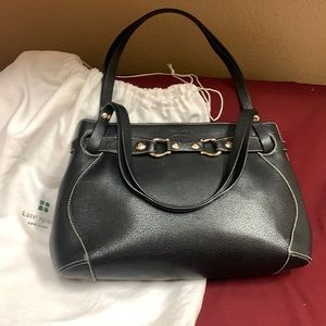 Kate Spade black leather bag with gold equestrian hardware.
